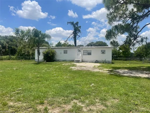 Rear view of property featuring a lawn