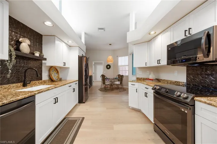Looking from other side of kitchen - you have a 2nd dining space in the Kitchen - "breakfast area". The far door leads to the laundry room and then to the garage.