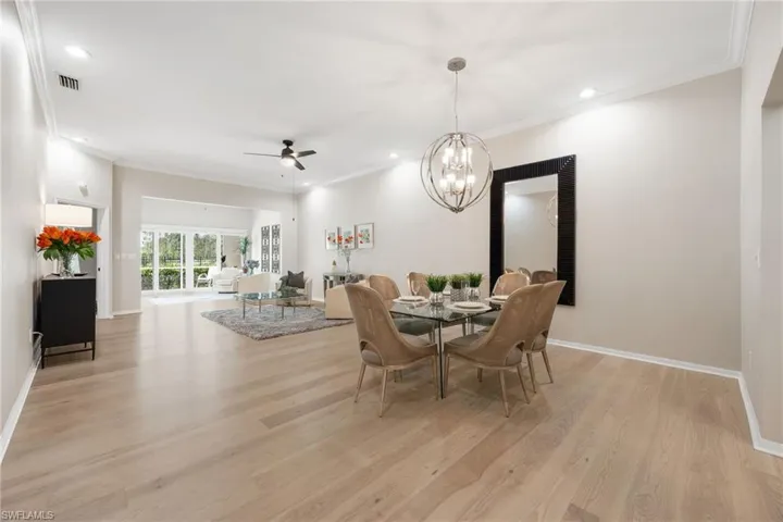 Just WOW! Gorgeous space and room ~ recessed lighting, ceiling fans thoughout, crown molding, 10 ft ceilings.  There is dining, living room, a gathering space in the back and screened lanai. Perfect for entertaining and relaxing.