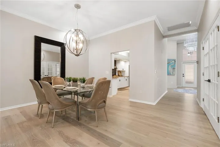 View from Front Entry into home. See full glass front door. From front entrance you can enter into the kitchen on right, 2nd bedroom on left, den with french doors on left and come into the main Dining / Living space.