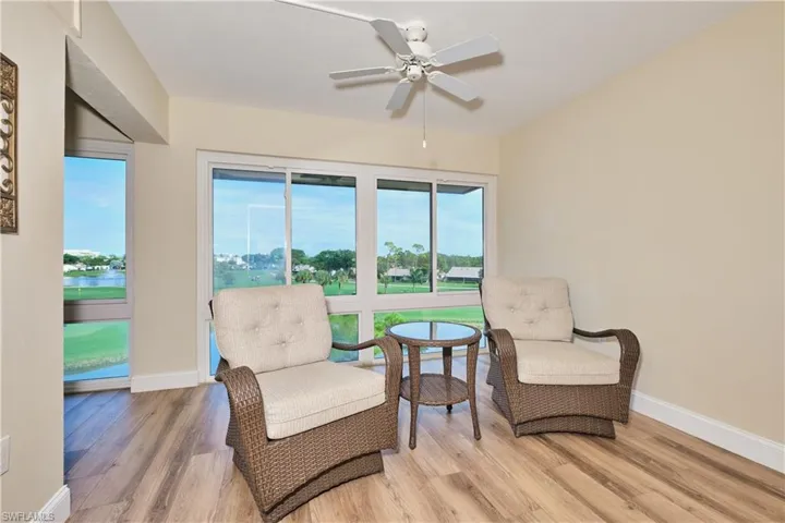 Sitting room with wood finished LTV floors and a ceiling fan