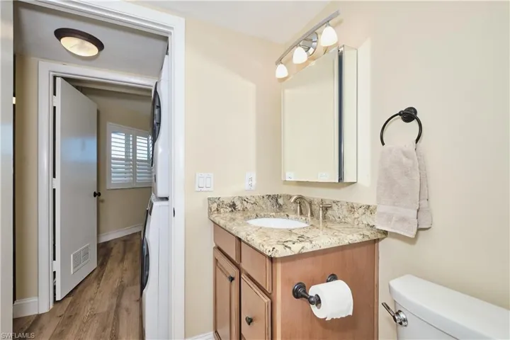Guest bath located right next to the washer and dryer.