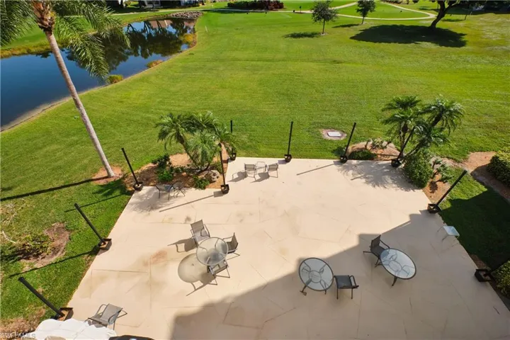 Community patio with gas grill, party lights, and beautiful golf course views.