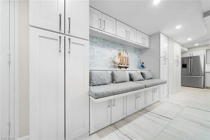 Mudroom with light tile patterned flooring