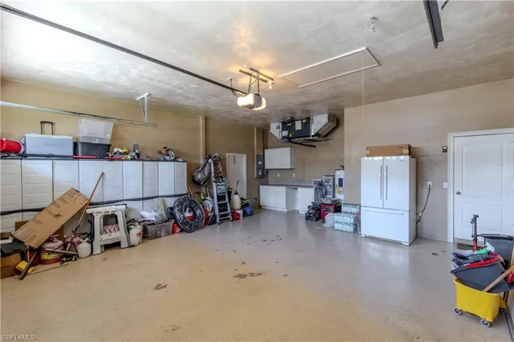 Oversized 2 car Garage featuring a garage door opener
