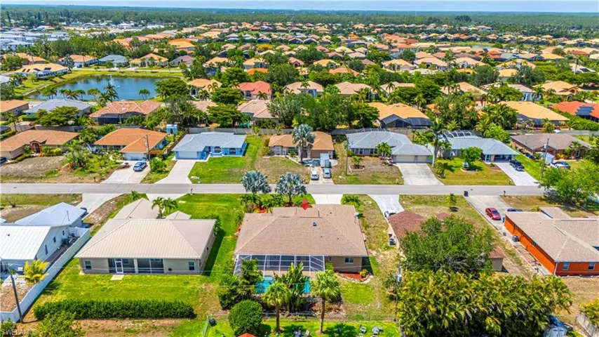 Aerial perspective of suburban area with a nearby body of water