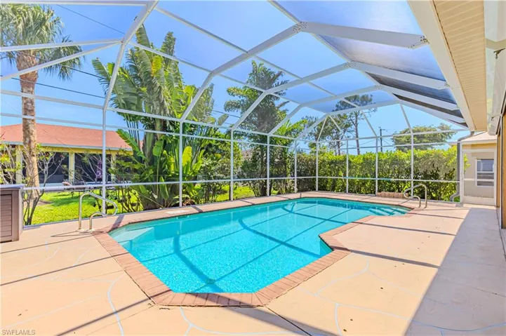 Outdoor pool featuring a patio and screen enclosure