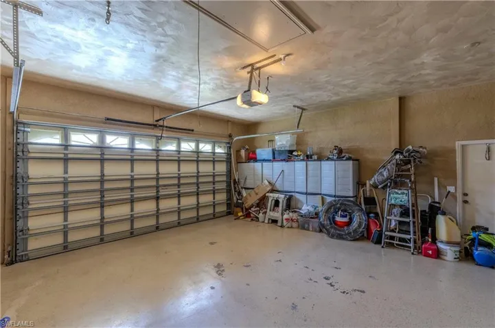 Oversized 2 car Garage featuring a garage door opener