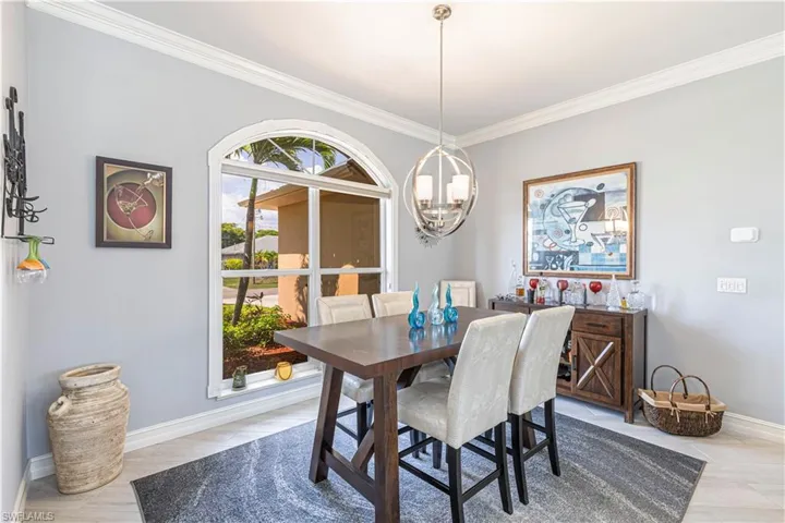 Dining area featuring a chandelier, ornamental molding and baseboards