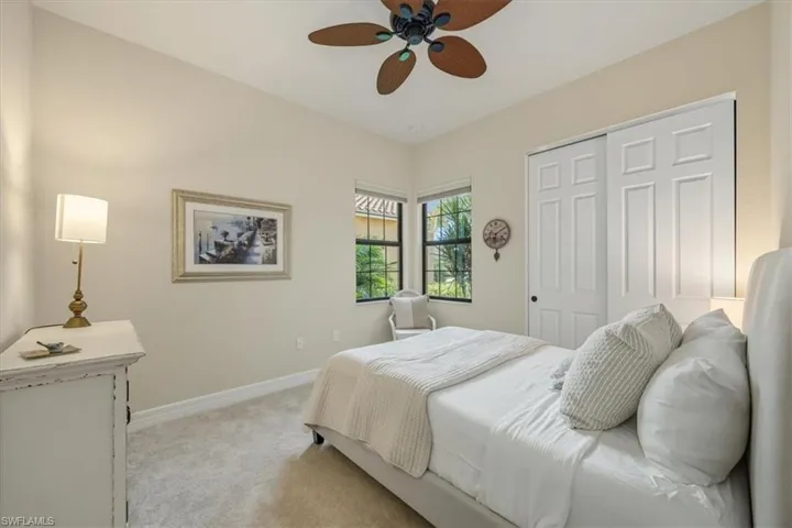 Bedroom with carpet floors, a ceiling fan, and a closet