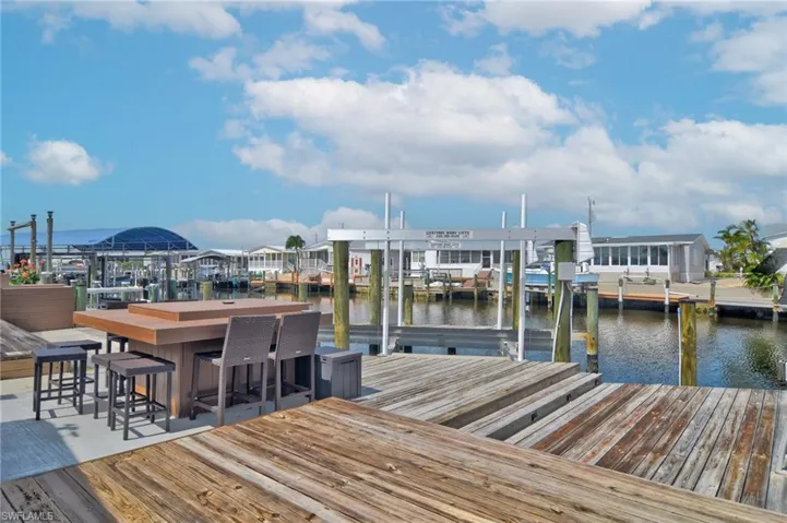 Dock area with a water view and boat lift