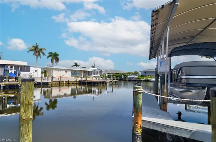 Dock featuring a residential view and a water view