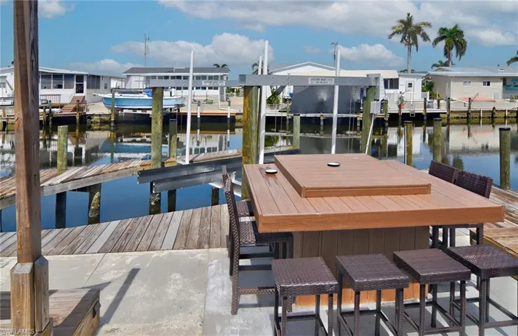 Dock area with a water view and boat lift
