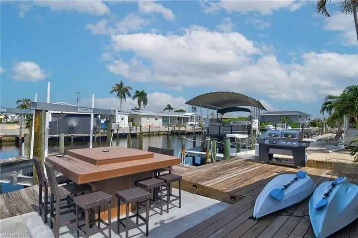 Dock area with a water view and boat lift