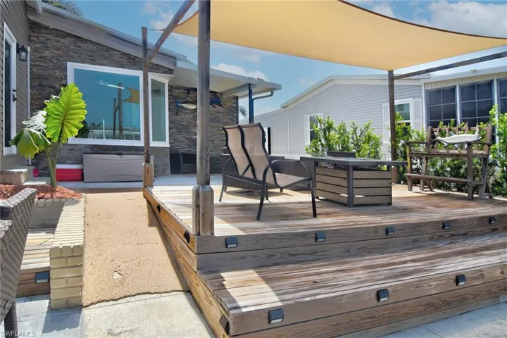 Wooden deck with outdoor lounge area and a patio