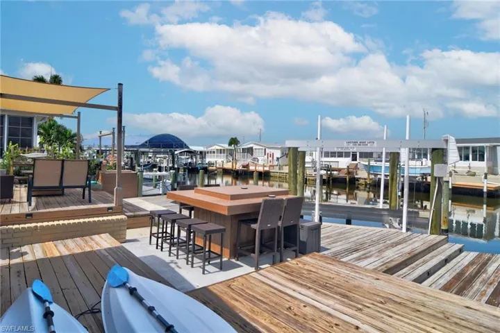 Dock area featuring a deck with water view and boat lift