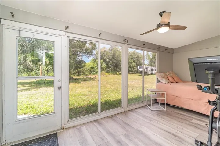Den/sunroom featuring plenty of natural light.