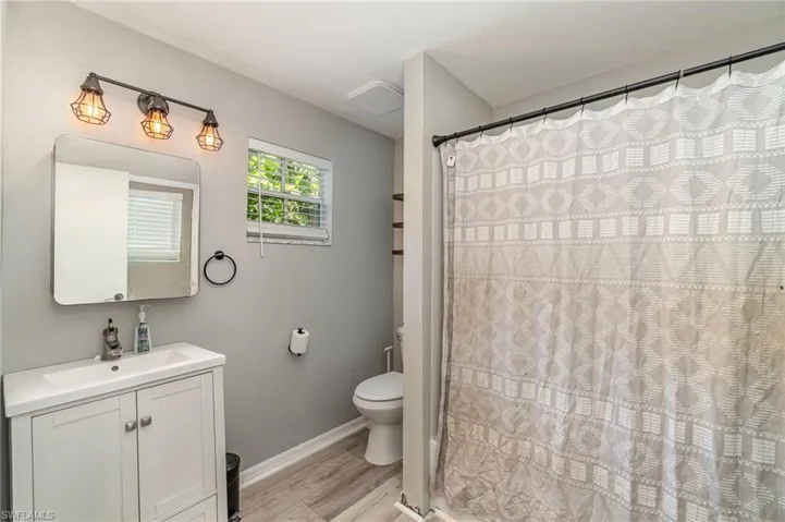 2nd Bathroom featuring hardwood / wood-style flooring, vanity, and toilet