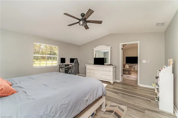 Bedroom featuring ceiling fan, light hardwood / wood-style flooring.