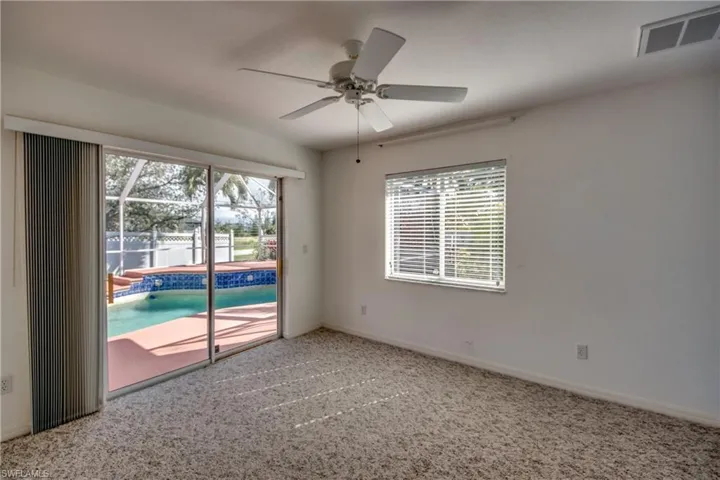Spare room with carpet flooring and ceiling fan