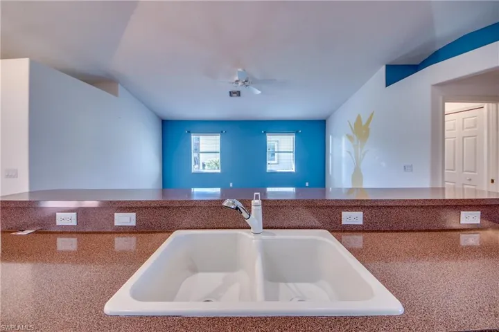 Kitchen featuring sink and ceiling fan