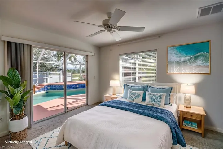 Bedroom with ceiling fan, access to exterior, carpet, and multiple windows