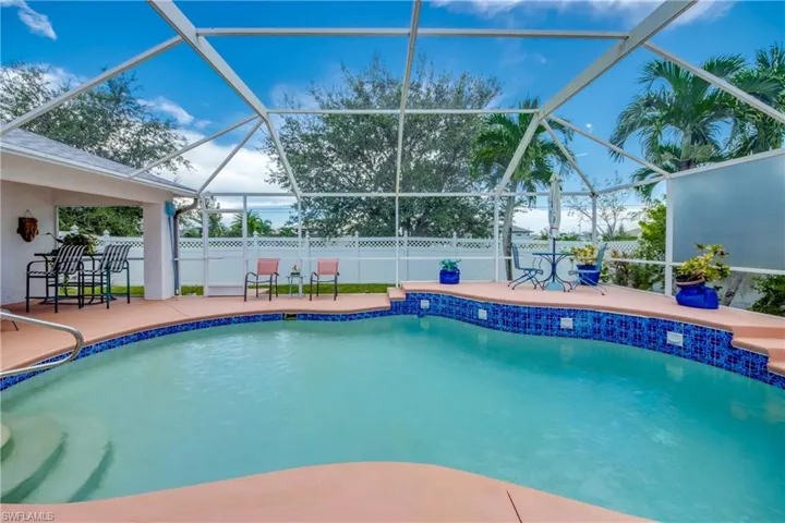 View of swimming pool featuring a patio and a lanai