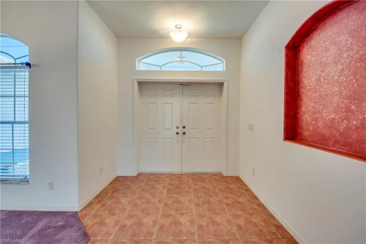 Entrance foyer featuring light tile patterned flooring