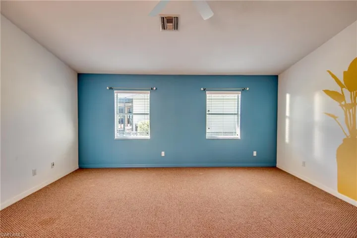 Spare room with light colored carpet and ceiling fan