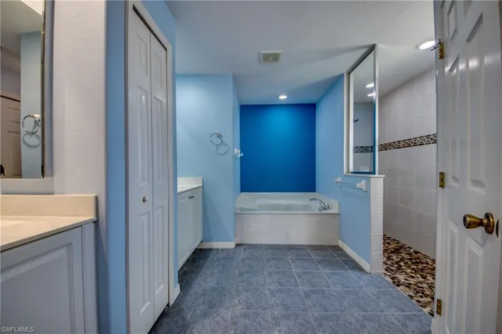 Bathroom featuring vanity and separate shower and tub
