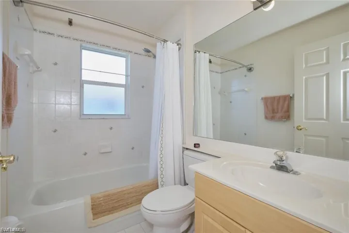 Bathroom with vanity and shower / tub combo with curtain