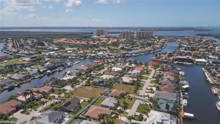 View of property location with a large body of water and nearby suburban area