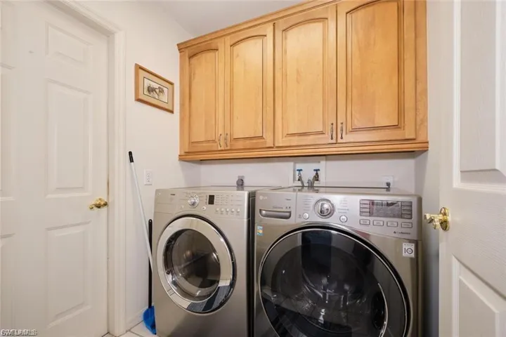 Laundry room featuring washer and dryer and cabinet space