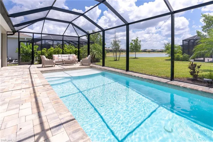 Swimming pool featuring a lawn and a lanai