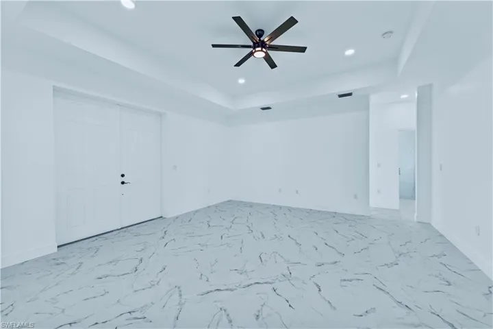 Spare room featuring ceiling fan and a raised ceiling