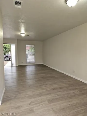 Empty room with light wood-style floors and baseboards