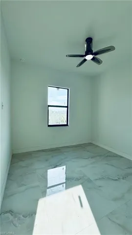 Unfurnished room featuring ceiling fan