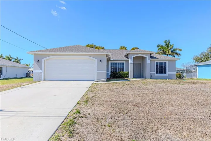 Ranch-style house with an attached garage, concrete driveway, stucco siding, and a shingled roof