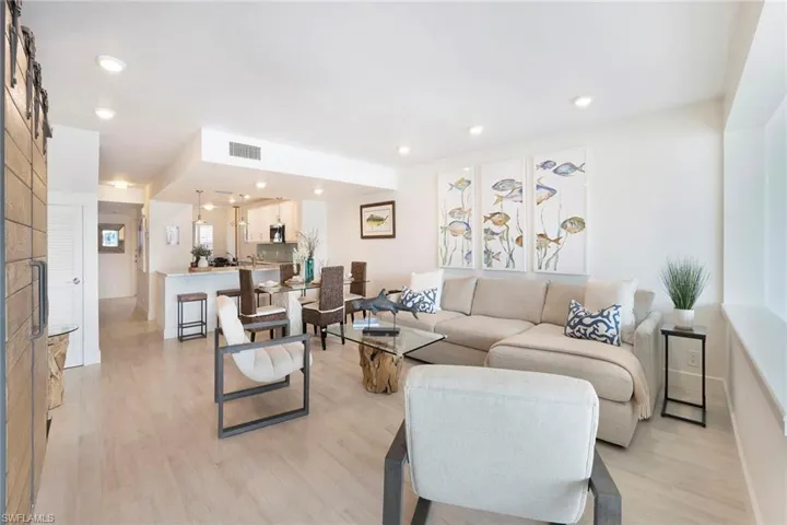 Living area with light wood-style flooring and recessed lighting