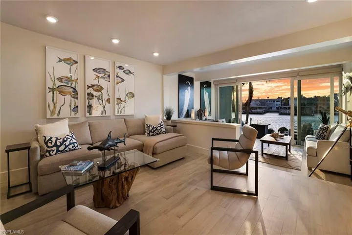 Living area featuring a water view, recessed lighting, and wood finished floors