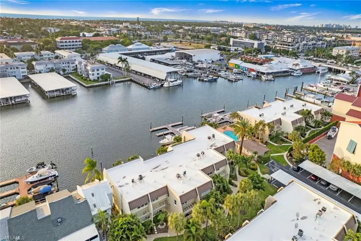 Drone / aerial view of a nearby body of water and a marina