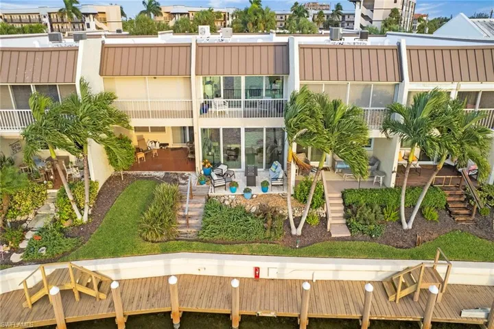 Back of property with stairway, stucco siding, and a patio area