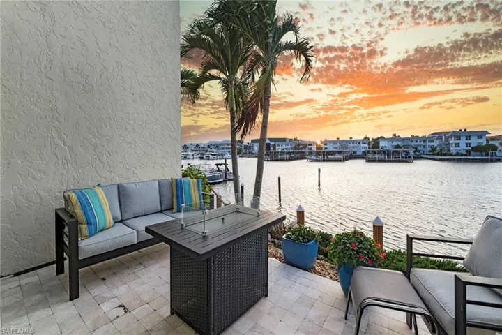 View of patio / terrace featuring an outdoor hangout area, a water view, and a boat dock