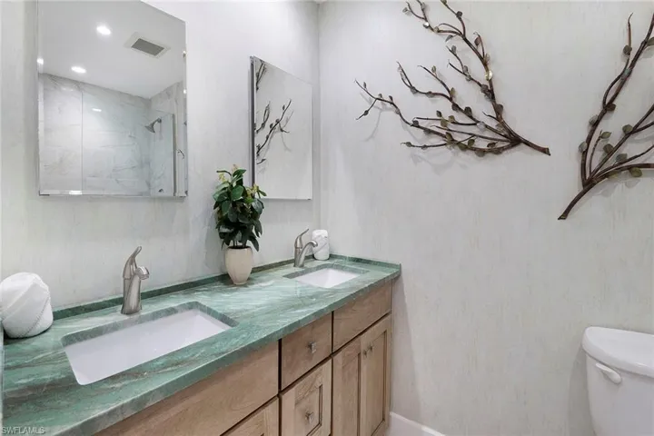 Bathroom featuring double vanity and a shower