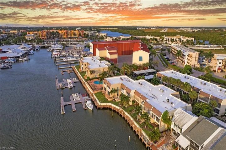 Aerial view at dusk of a water view and view of marina