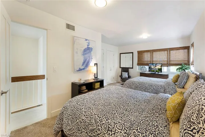 Bedroom featuring carpet flooring and baseboards