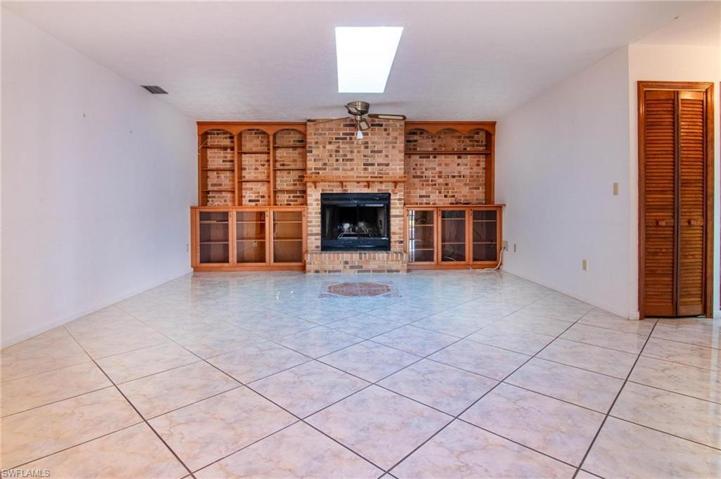 Stunning wood cabinetry surrounds custom brick fireplace!