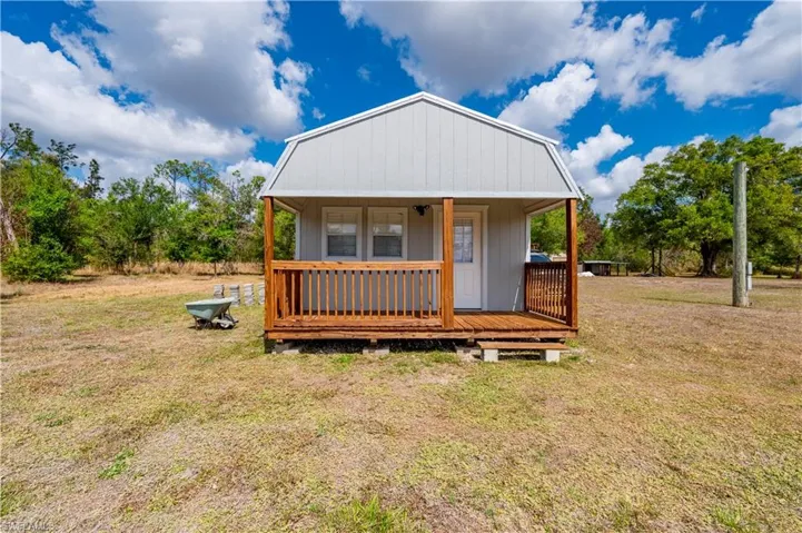 View of front of property with a front yard and a porch