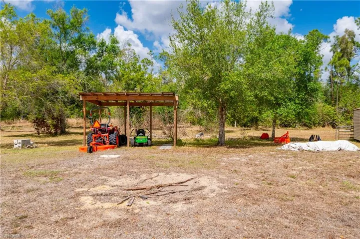 View of yard with a carport