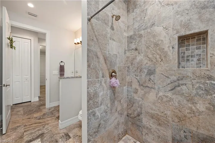 Bathroom featuring walk in shower and toilet